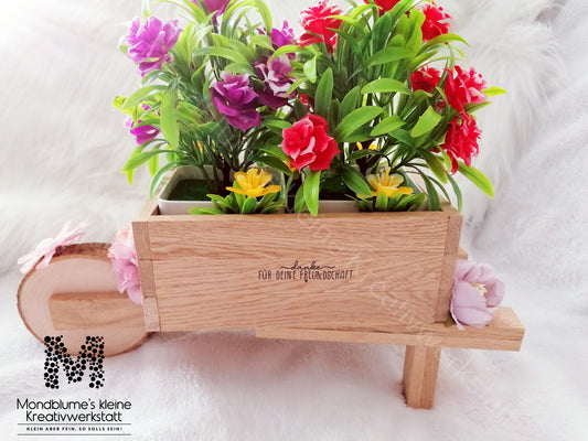 Schubkarre hell, befüllt mit Blumen